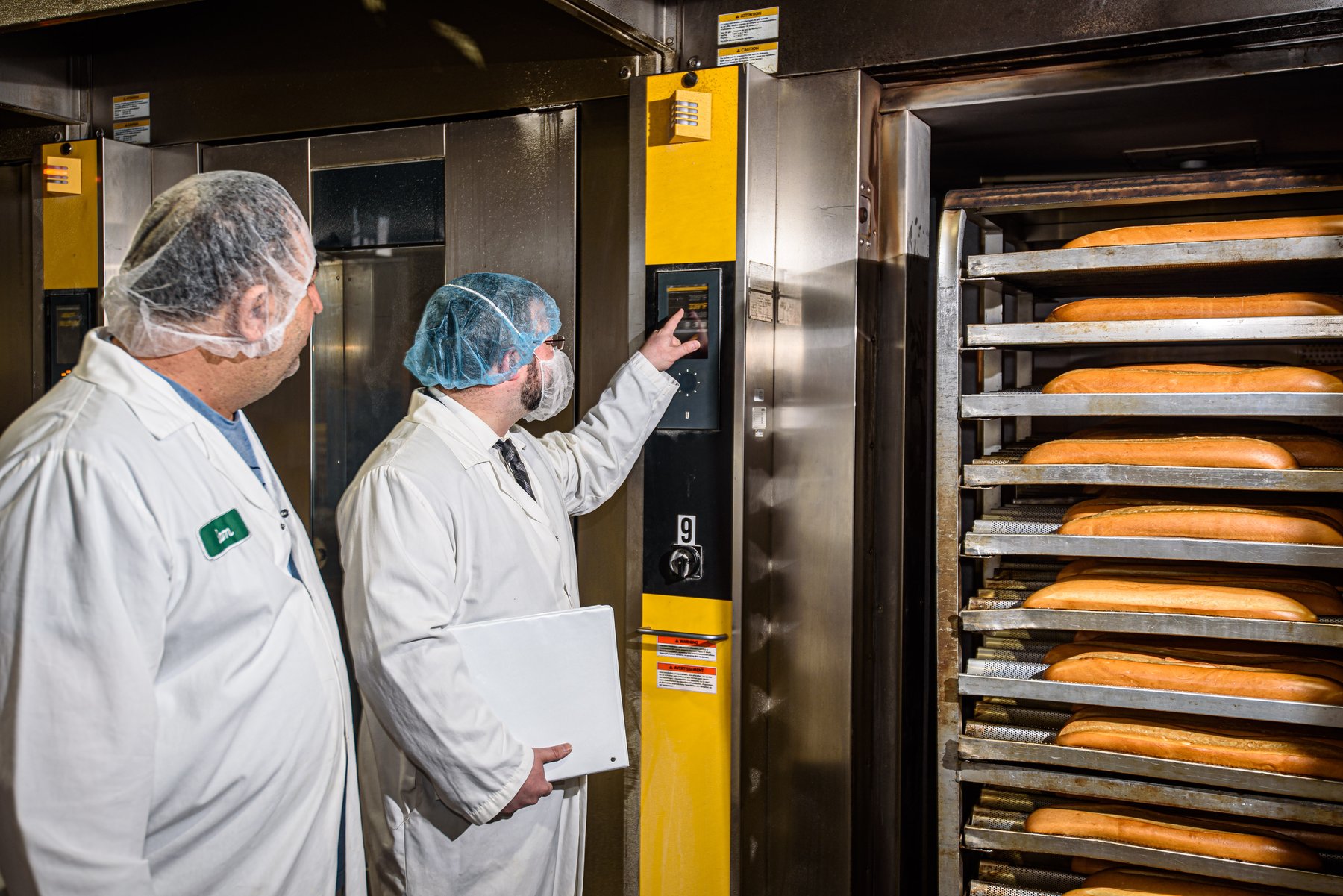 VegeCert inspector reviewing oven controls during a bakery facility inspection